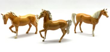 Three Beswick horses in palomino gloss comprising Arab type No. 1261, first version, Stocky Jogging