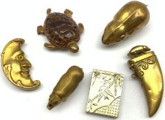 Six novelty vesta cases comprising embossed brass man in the moon, another in the form of a tigers