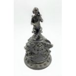19th century bronze hand bell, the handle formed as a seated cherub in the style of a 16th century V