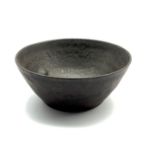 Dame Lucie Rie DBE (1902-1995) a small stoneware bowl with manganese glaze, impressed seal mark D8.5