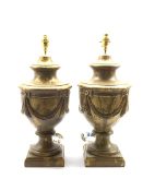Pair of modern pottery table lamps, of urn form, relief moulded with gilt swags against a gilt groun