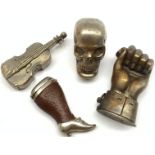 Four novelty vesta cases comprising plated skull, plated cello, leather and plated case in the form