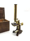 19th century brass microscope on cast iron base with four lenses in wooden case