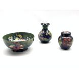 Moorcroft Orchid pattern bowl on green ground, D19cm and Moorcroft vase and ginger jar decorated in
