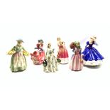 Six Royal Doulton figures comprising Carolyn, Miss Demure, Top O' the Hill, Daffy, Queen Victoria li