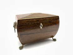 Regency rosewood two division tea caddy of sarcophagus form, brass lion mask handles above paw feet,