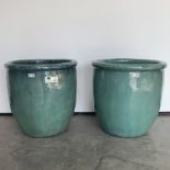 Two green glazed terracotta egg cup planters, D50cm