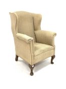 Georgian design wing back armchair, upholstered in cream fabric, raised on walnut cabriole front su