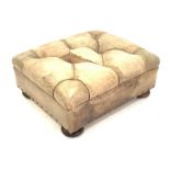 Square leather footstool upholstered in deep buttoned green tan leather, raised on compressed bun s