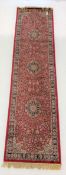 Persian design red ground runner rug, with three medallions on red field, 78cm x 310cm