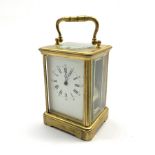 Early 20th century brass and bevelled glass carriage clock, white enamel dial with Arabic and Roman