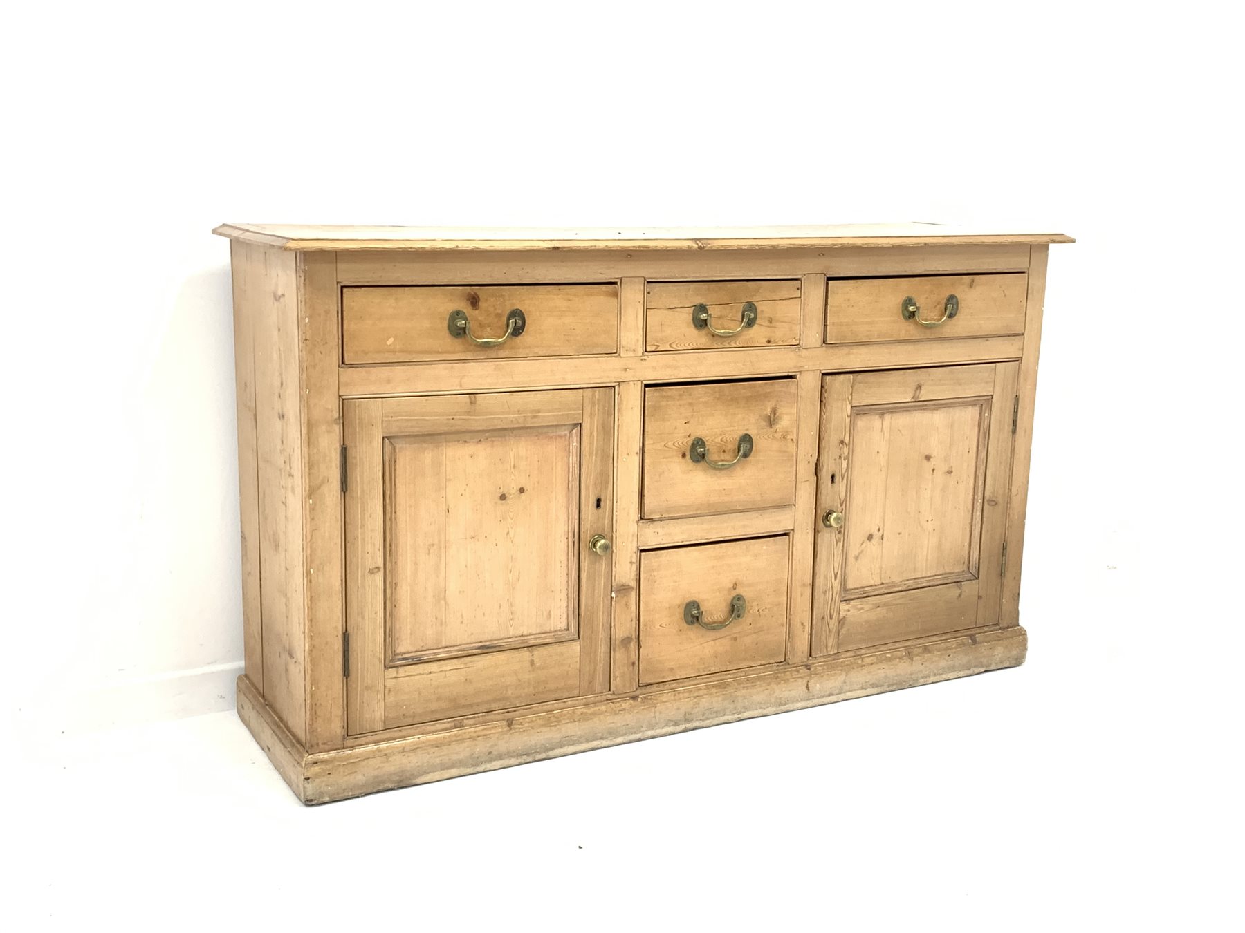 Late 19th century waxed pine dresser base, with five drawers and two panelled cupboards enclosing s
