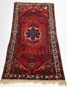 Red ground hand knotted Persian Hamadan rug with geometric design on red field, 102cm x 212cm