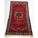 Red ground hand knotted Persian Hamadan rug with geometric design on red field, 102cm x 212cm