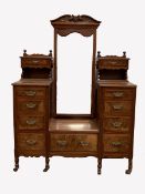 Edwardian walnut dressing chest, with angle poised mirror and ten short and one long drawers, raise