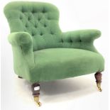 Victorian mahogany framed button back armchair upholstered in green velvet, raised on turned suppor