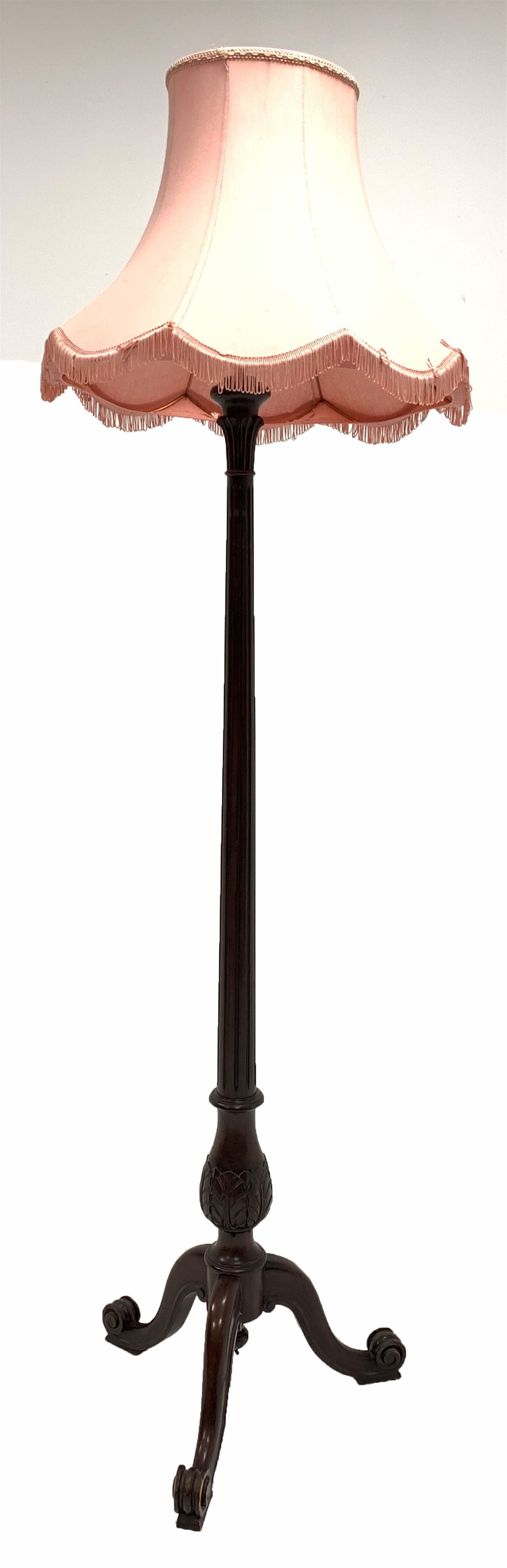Quality mahogany 1920's standard lamp, with leaf carved and fluted column raised on triple spay sup