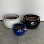 Six glazed terracotta planters of varying colours and sizes, D54cm