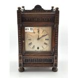 Late Victorian carved oak cased mantel timepiece, silvered dial with Roman numeral chapter ring, ei
