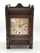 Late Victorian carved oak cased mantel timepiece, silvered dial with Roman numeral chapter ring, ei