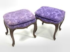 Pair of continental walnut upholstered dressing table stools, raised on scroll carved cabriole supp