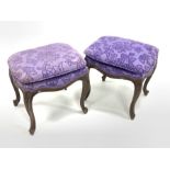 Pair of continental walnut upholstered dressing table stools, raised on scroll carved cabriole supp