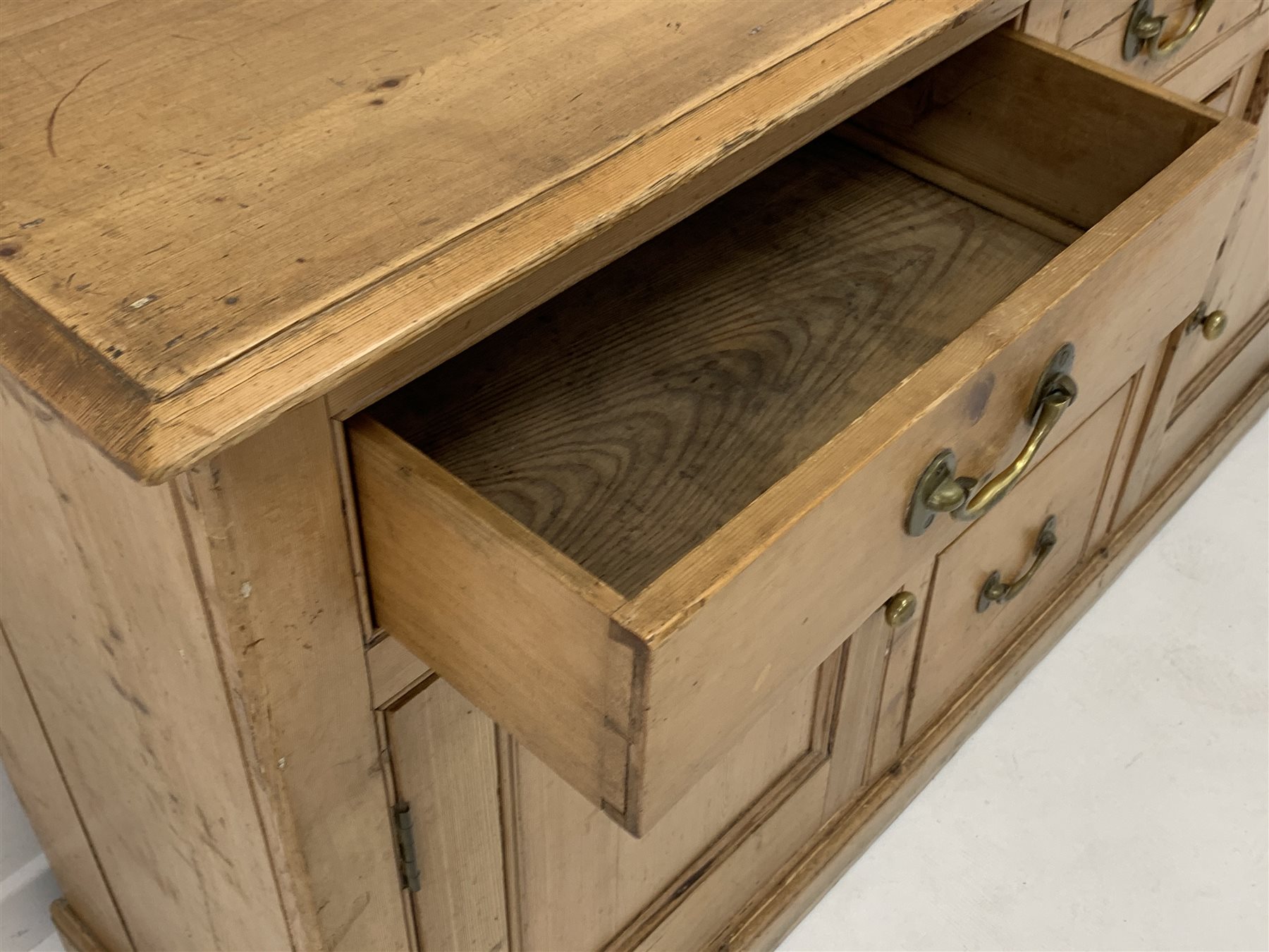 Late 19th century waxed pine dresser base, with five drawers and two panelled cupboards enclosing s - Image 3 of 6