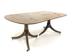 Regency design mahogany dining table with cross banded top raised on two pedestals each with reeded