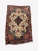 Persian hand knotted cream ground rug, with lozenge medallion surrounded by interlaced foliate, gua