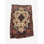 Persian hand knotted cream ground rug, with lozenge medallion surrounded by interlaced foliate, gua