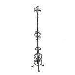 Arts and Crafts wrought iron oil lamp/candle stand, with decorative scroll work, H186cm