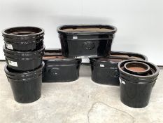 Three sets of three black glazed terracotta plant pots (W57cm) and approx 9 other black glazed cyli