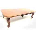 Large Victorian walnut extending dining table, the moulded top with 'D' shaped ends raised on leaf