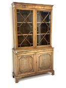 George III style mahogany bookcase on cupboard, moulded cornice above two astragal glazed doors, en