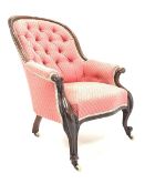 Victorian mahogany framed button back upholstered armchair, scroll carved arm terminals, raised on