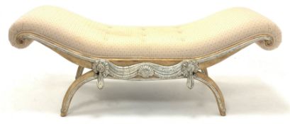 Painted hardwood window seat of classical design, upholstered in cream patterned fabric, decorated