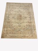 Aubusson style beige ground carpet with central medallion enclosed by trailing foliate, guarded bor