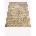 Aubusson style beige ground carpet with central medallion enclosed by trailing foliate, guarded bor