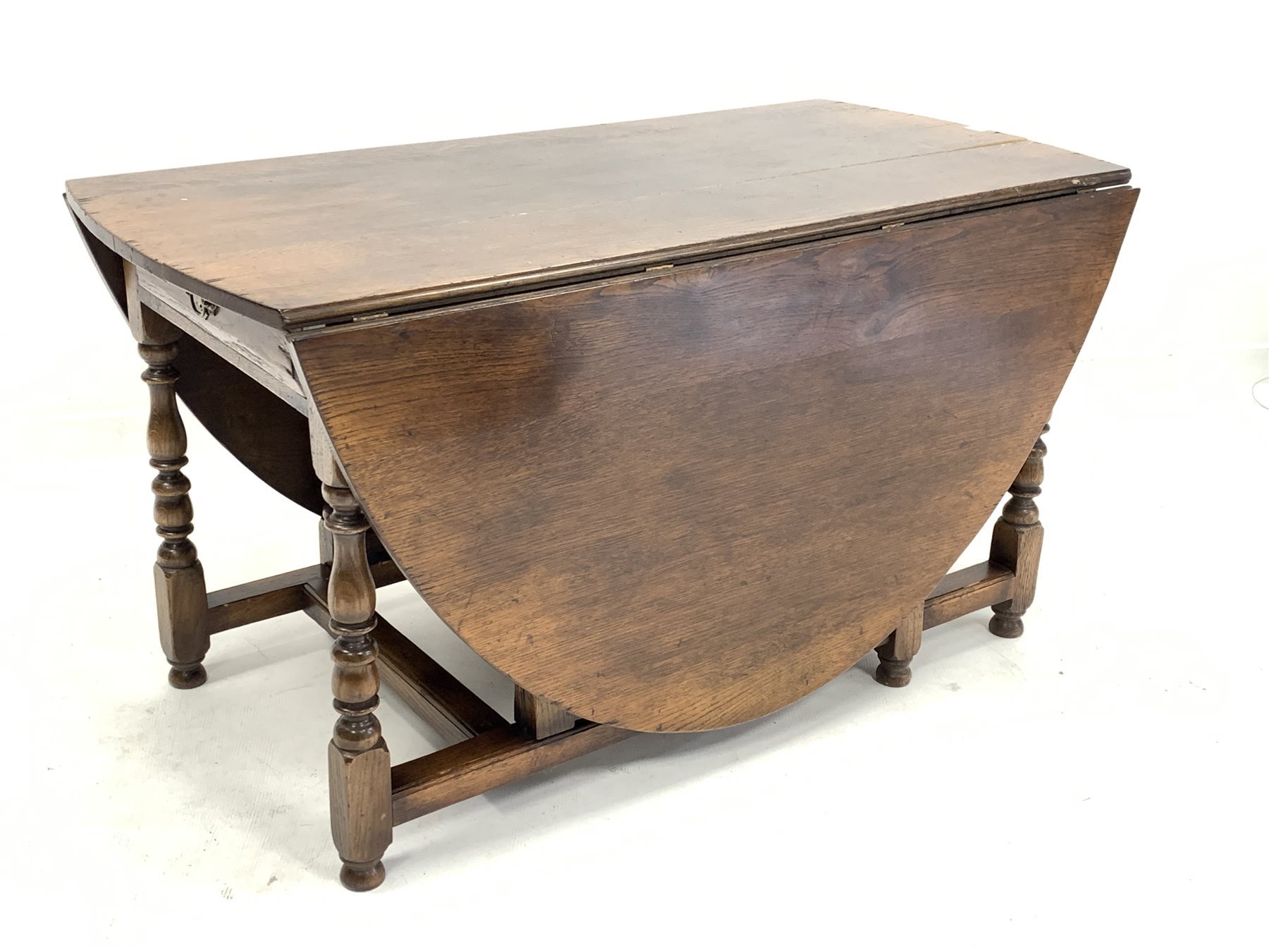 17th century style oval oak gateleg dining table, the oval top over single drawer and faux drawer t