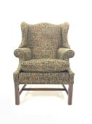 George III style wingback chair upholstered in green patterned fabric, with squab cushion, raised o