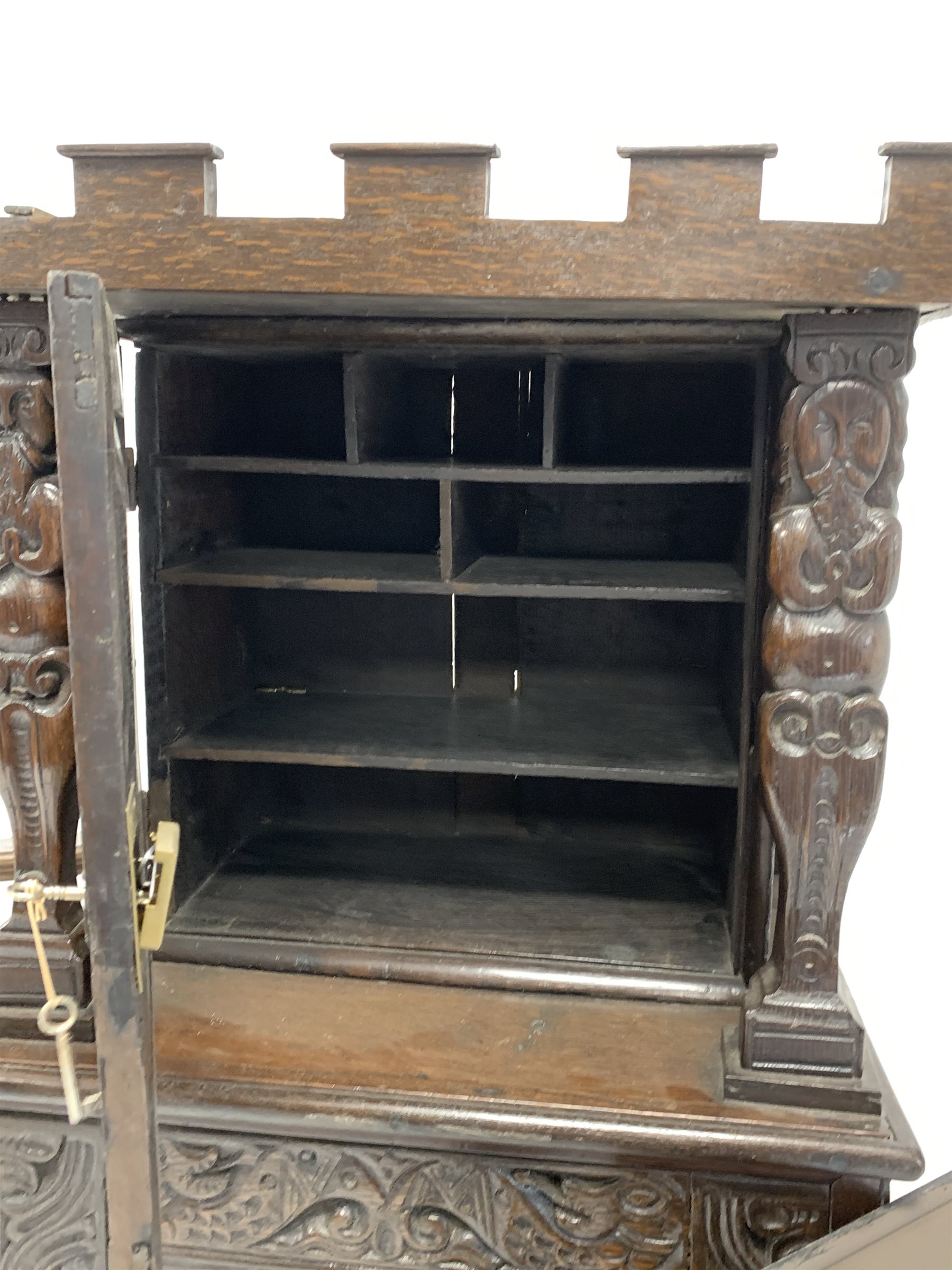 18th century inlaid and carved oak cupboard, with castellated top, two panelled doors and a drawer - Image 3 of 4