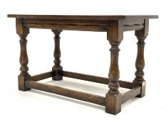 Traditional oak rectangular coffee table, with rectangular top raised on turned and block supports