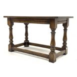 Traditional oak rectangular coffee table, with rectangular top raised on turned and block supports