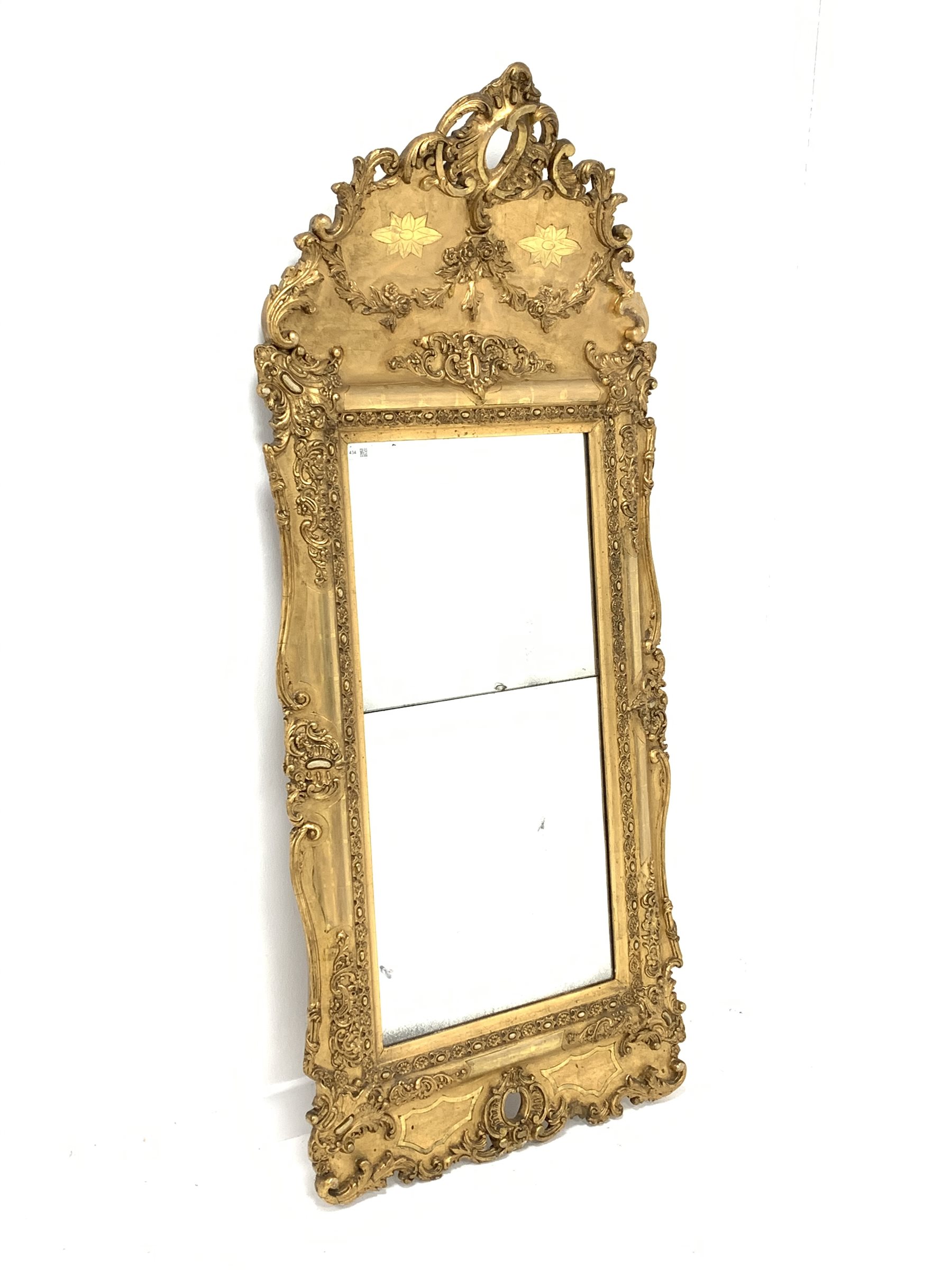 Late 19th century upright wall mirror with ornate leaf moulded gilt frame and two mirrored plates,