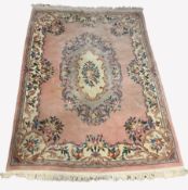 Chinese pink wool ground carpet with floral medallion and scrolled leaf border, 273cm x 400cm