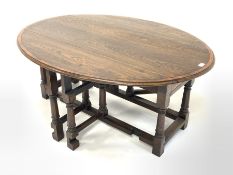 18th century style drop leaf occasional table, the oval top with mahogany cross banding over drawer