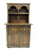 20th century carved oak dresser with one height plate rack over panelled cupboard enclosing shelf a