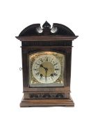 Late 19th century mantle clock in architectural walnut case, arched pediment with central leaf carve