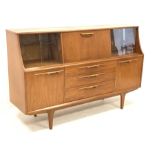 1970s teak sideboard, central fall front flanked by two sets of sliding glass doors, three drawers a