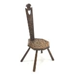 20th century oak spinning chair, relief carved with flower head, s scrolls and leafage, pierced hear